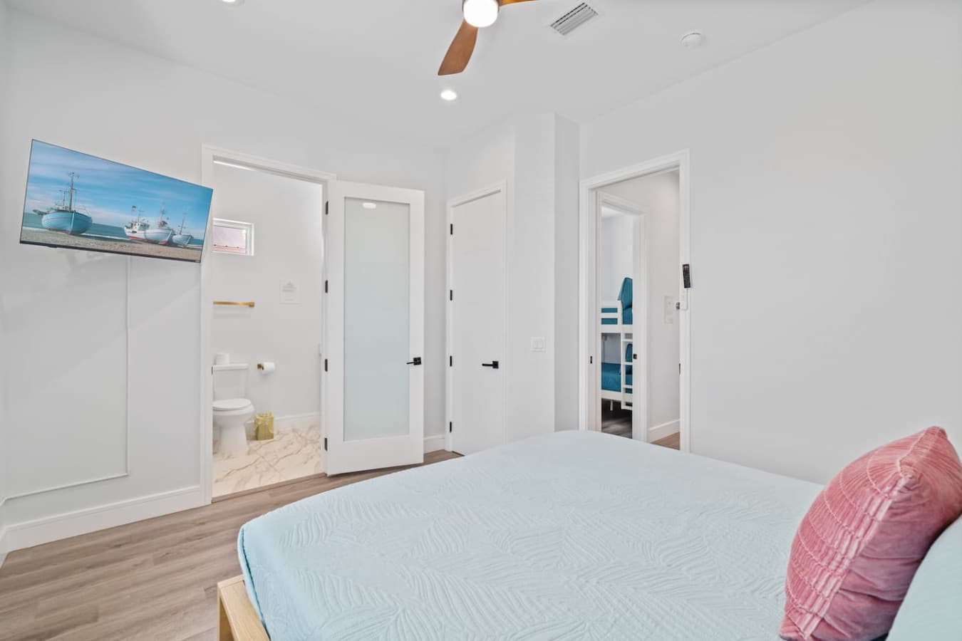 King bedroom located upstairs in the home with en suite bathroom and large smart TV