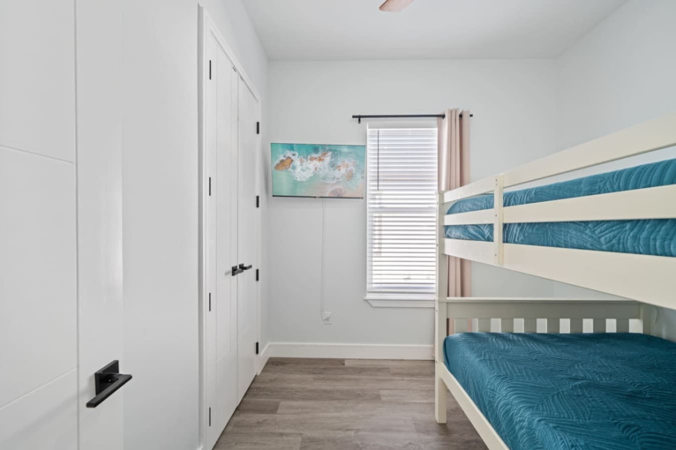 Full bunk beds upstairs in the home complete with a large smart TV