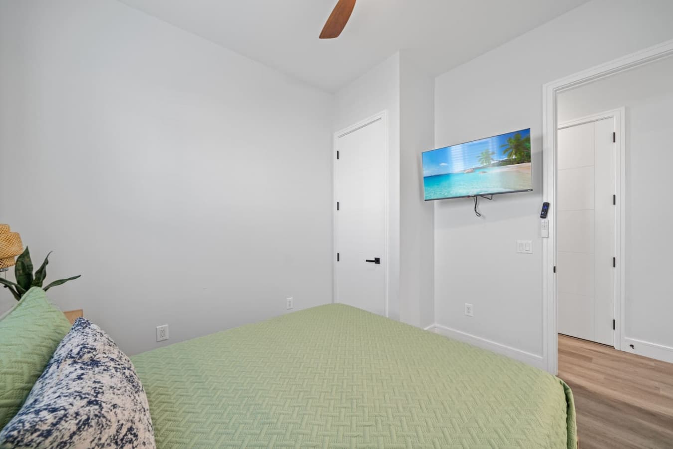 Queen bedroom located downstairs in the home with large smart TV