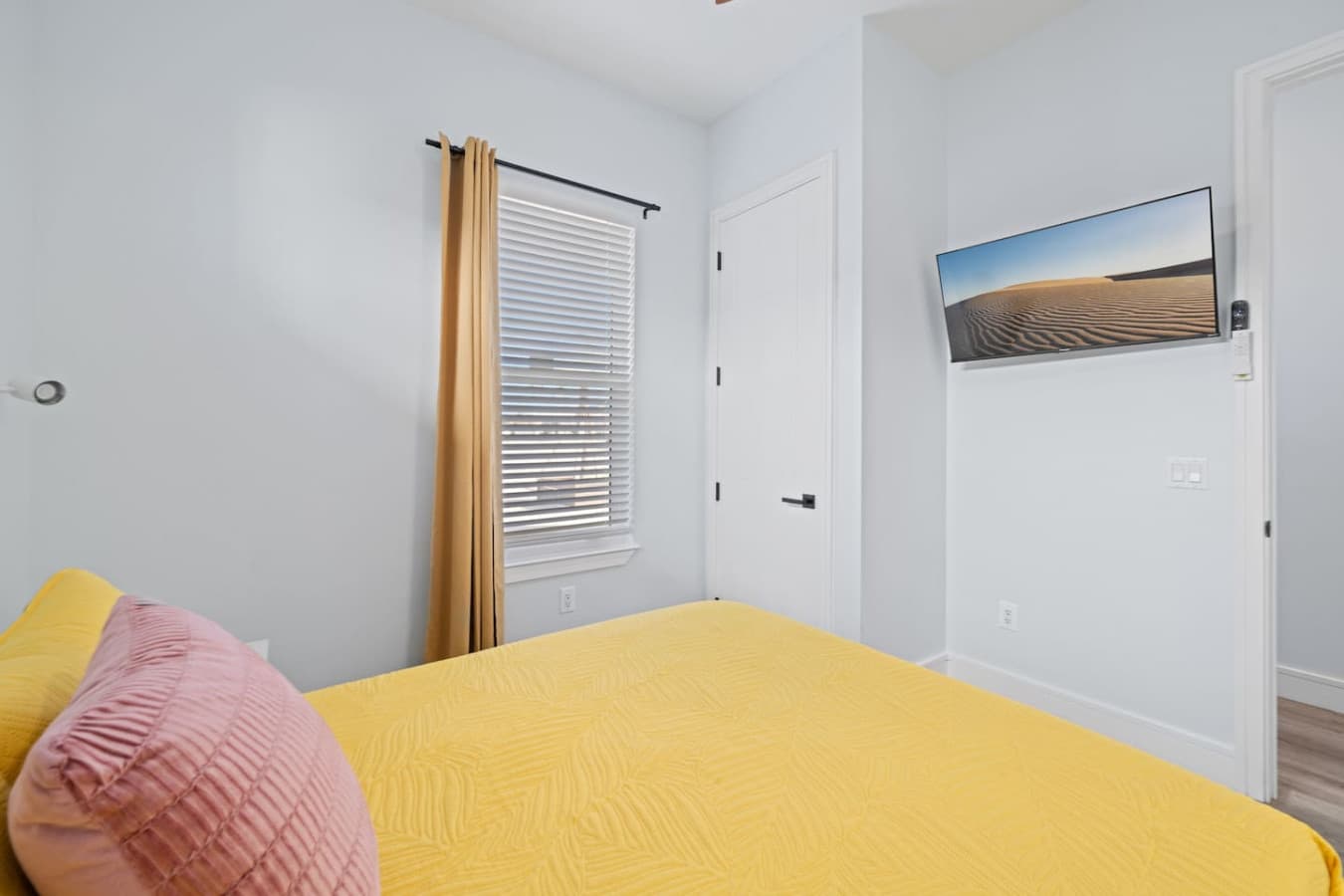 Queen bedroom downstairs with a large smart TV
