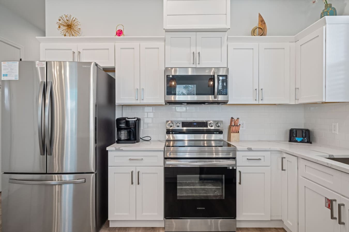 An open kitchen with a large refrigerator and 4-top burner on the main level