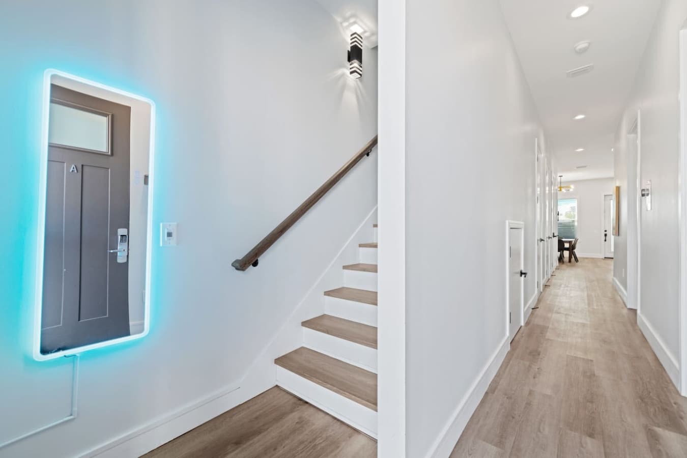Walking in the front door you're greeted with steps up to the second level on the left and the main hallway with two bedrooms and the kitchen, dining and living space straight ahead