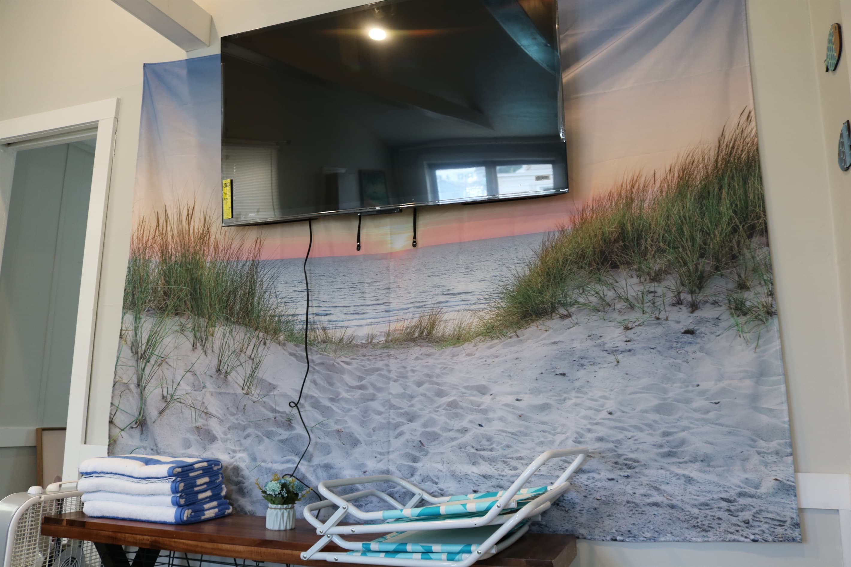 living room 55" Roku Smart TV and bench TV stand holding your beach chairs and towels