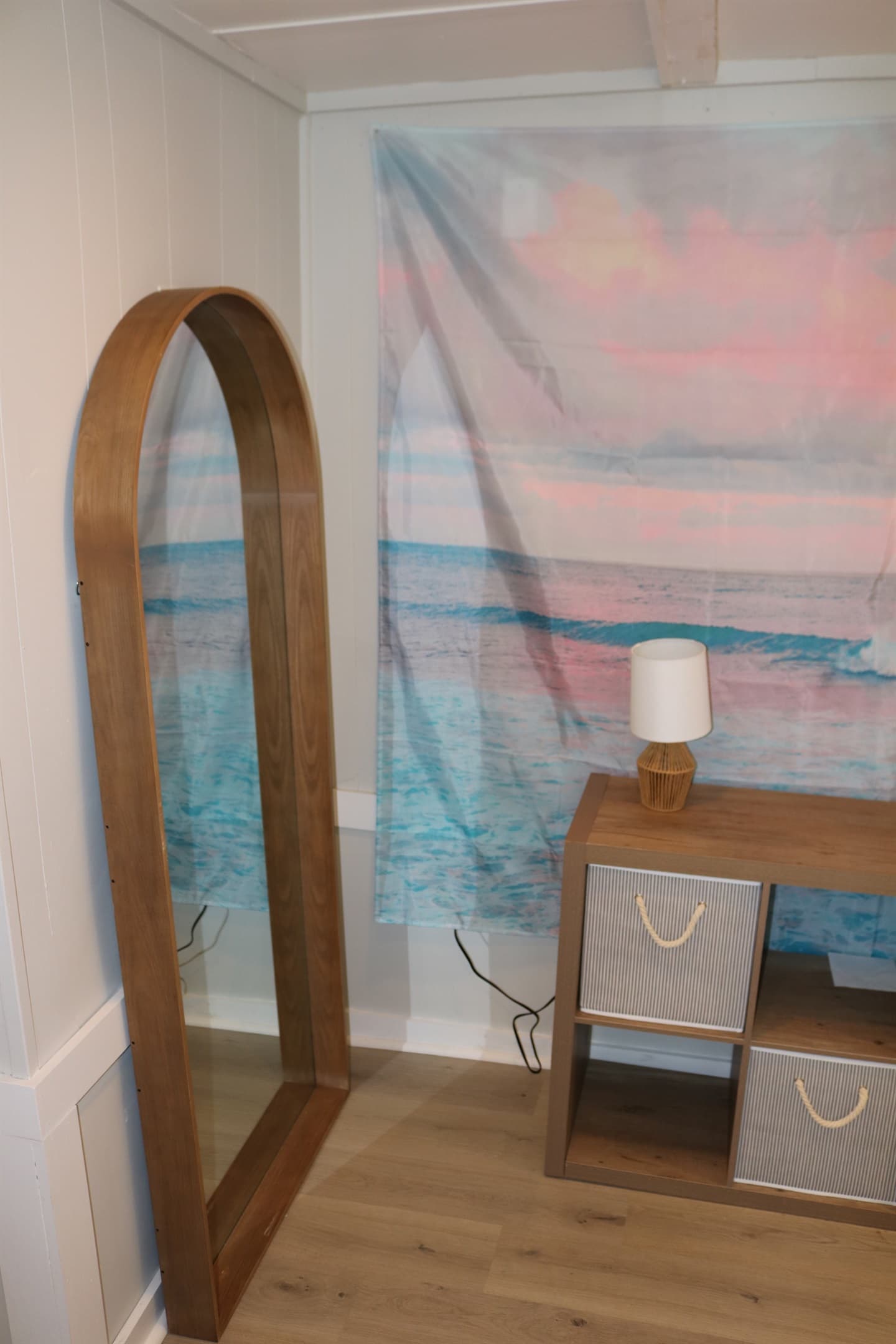 full size framed mirror sits alongside the storage dresser