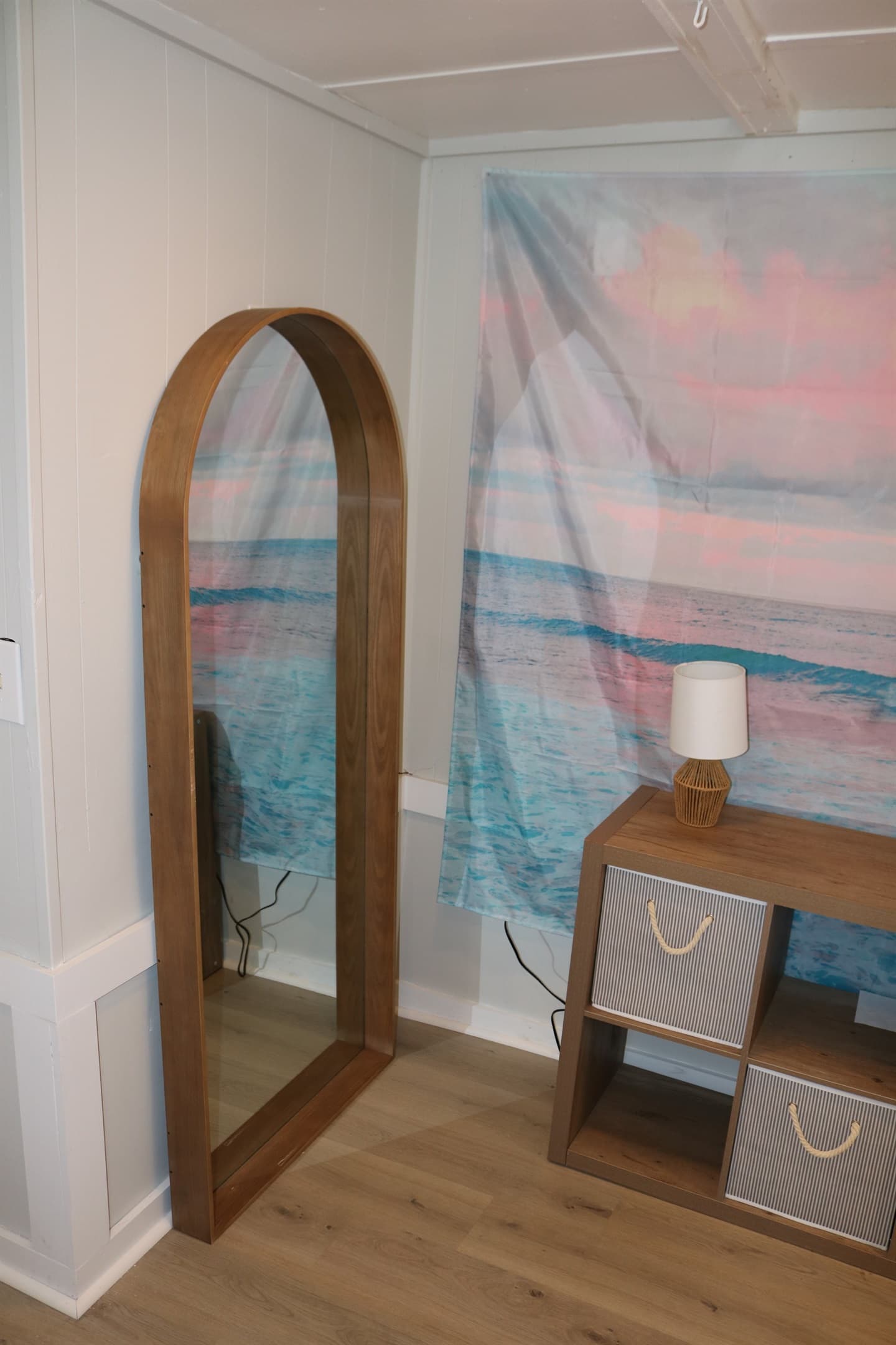 full size framed mirror sits alongside the storage dresser