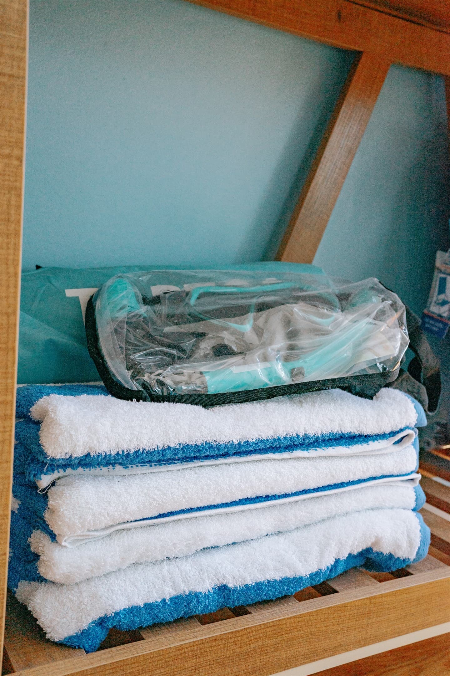 the tv stand in the living room, which includes beach towels, beach chairs, snorkel set & pop up tent