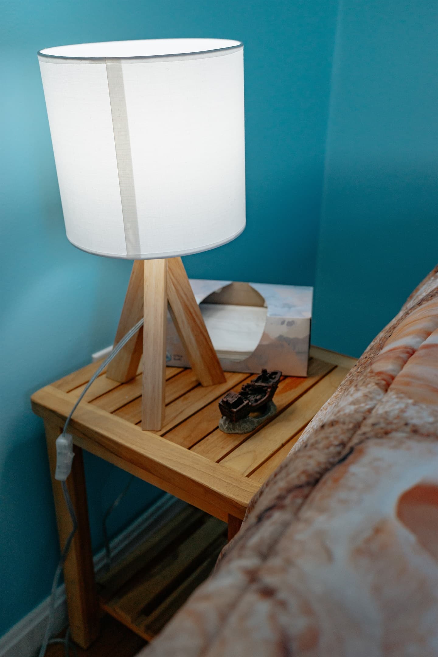 the night stand in the master bedroom. The stand is teak, and the lamp is controlled from the light switch on the wall