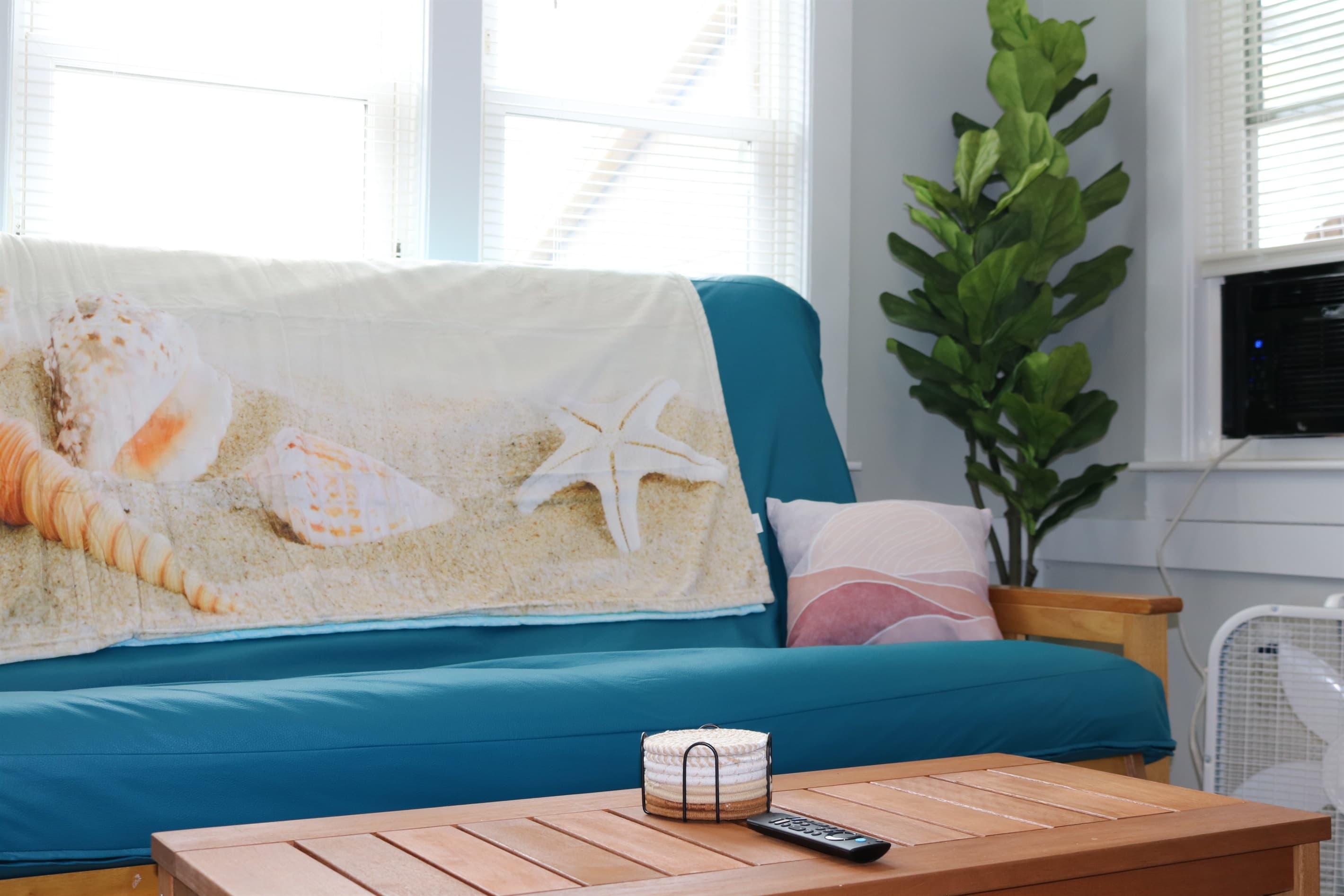 as you walk in, you are greeted by a full size queen futon couch, fan, a/c unit, and beautiful living room decorations