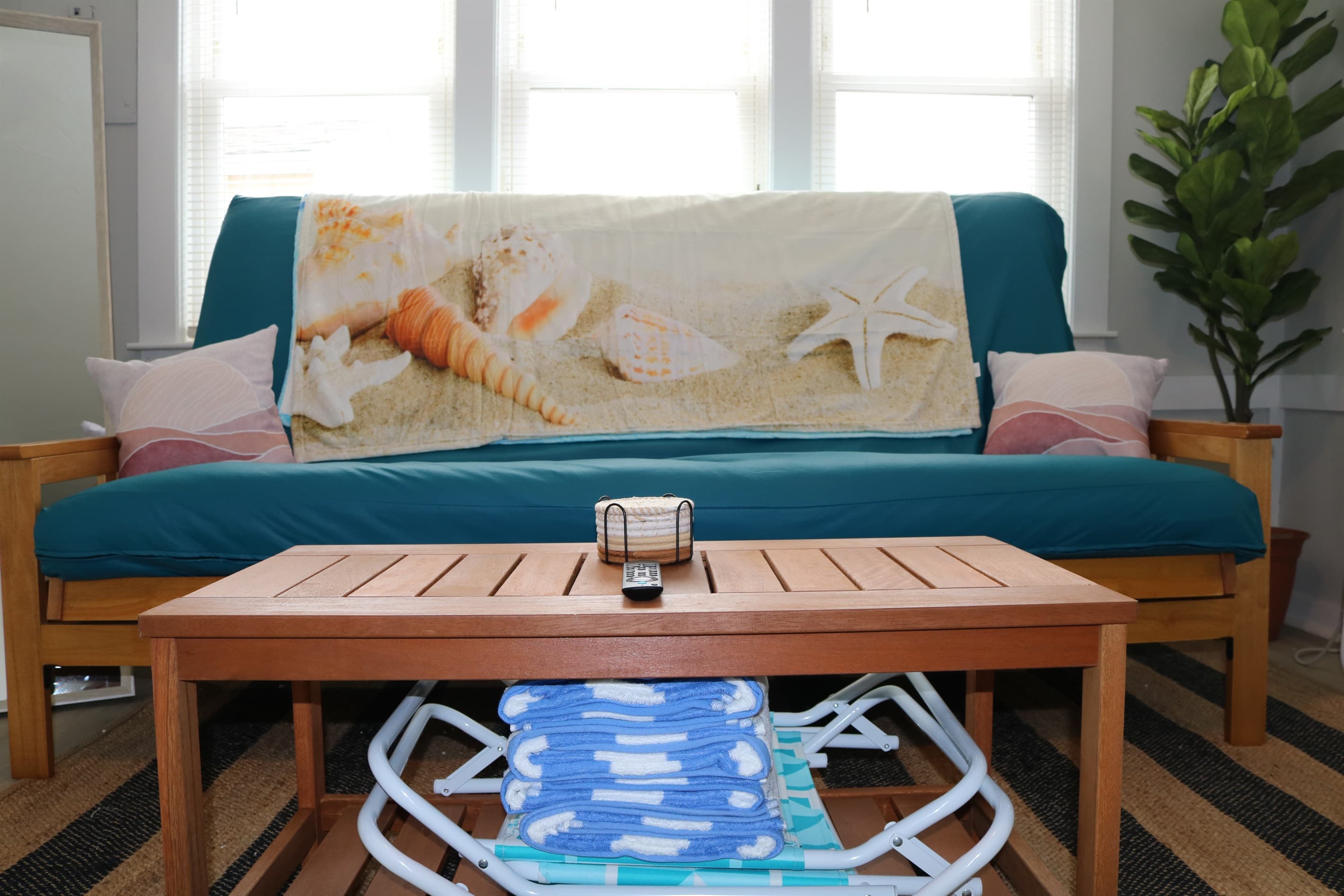 as you walk in, you are greeted by a full size queen futon couch, fan, a/c unit, and beautiful living room decorations