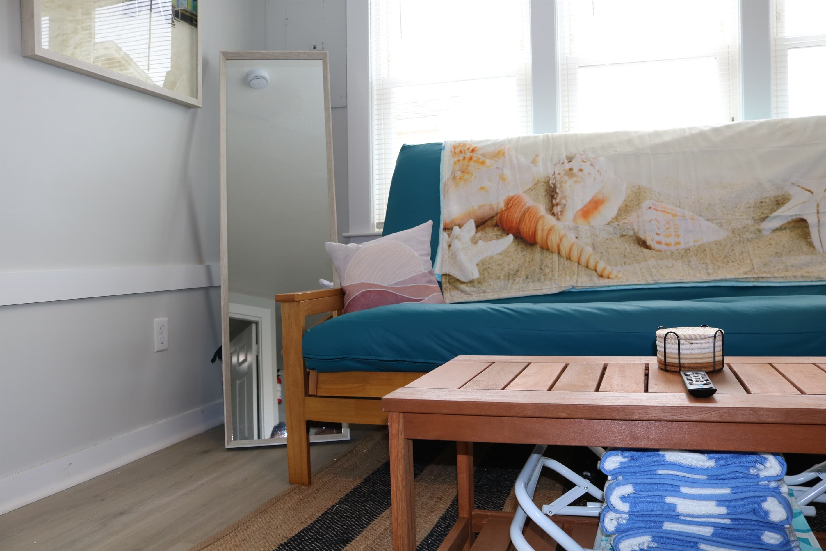 as you walk in, you are greeted by a full size queen futon couch, fan, a/c unit, and beautiful living room decorations