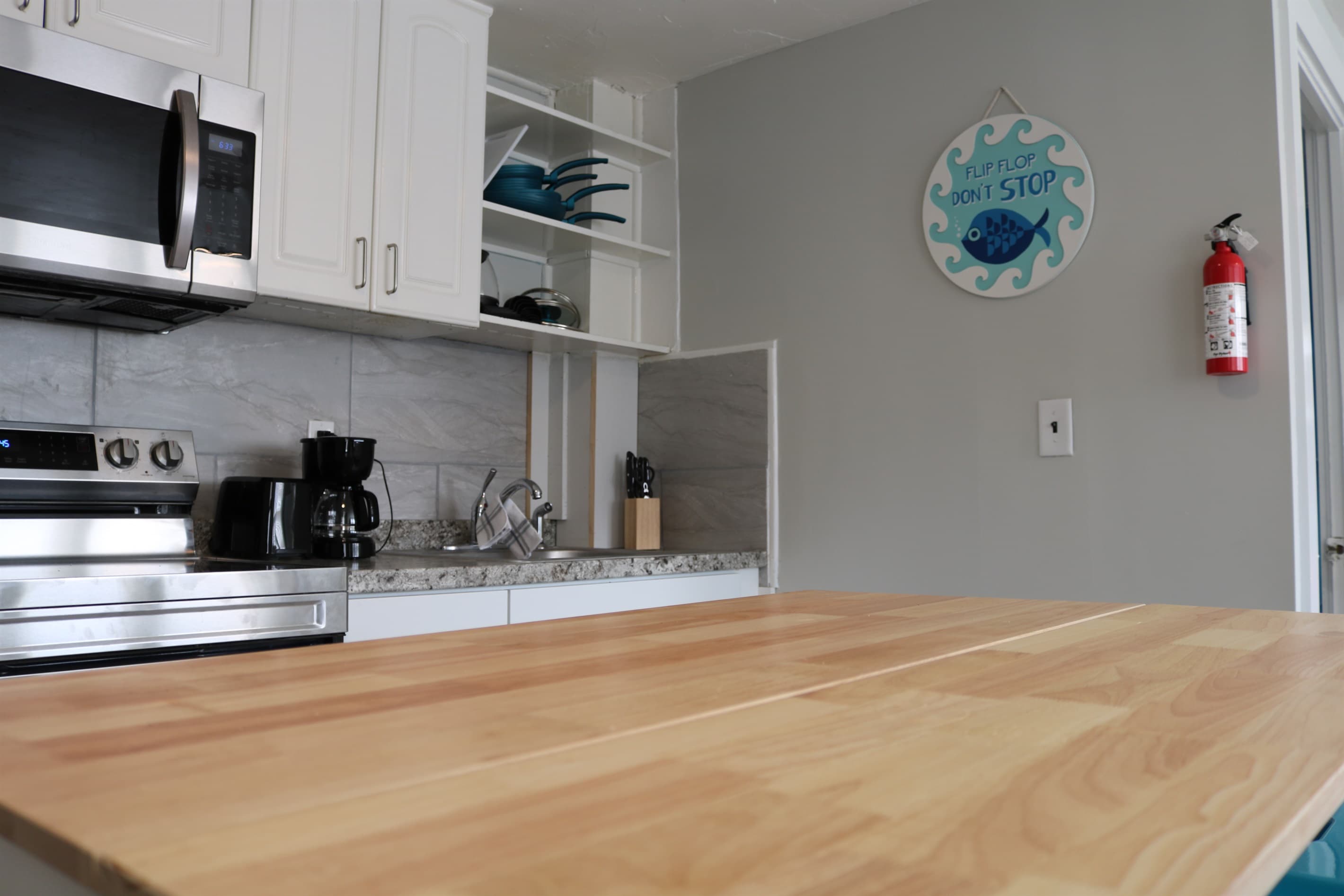 a fully stocked kitchen awaits complete with an island with seating for 2 and all the essentials.