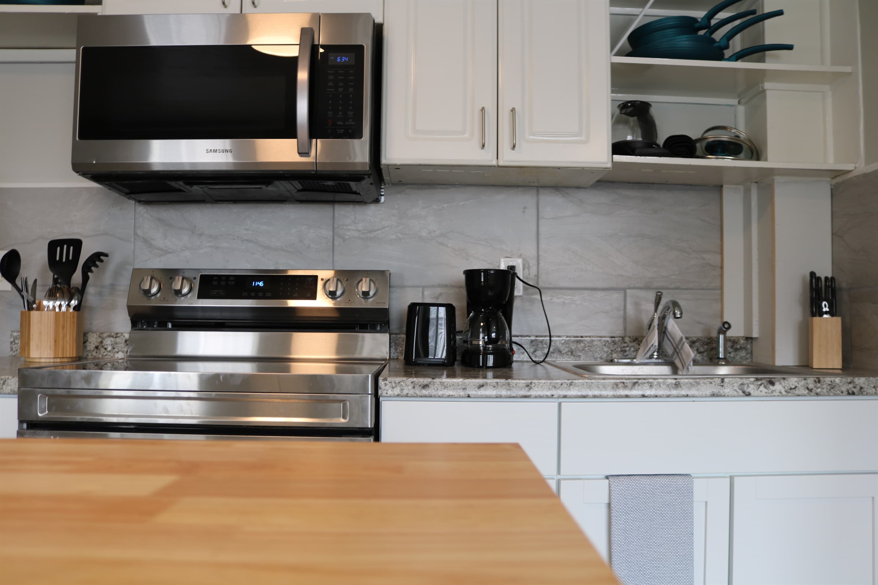 a fully stocked kitchen awaits complete with an island with seating for 2 and all the essentials.