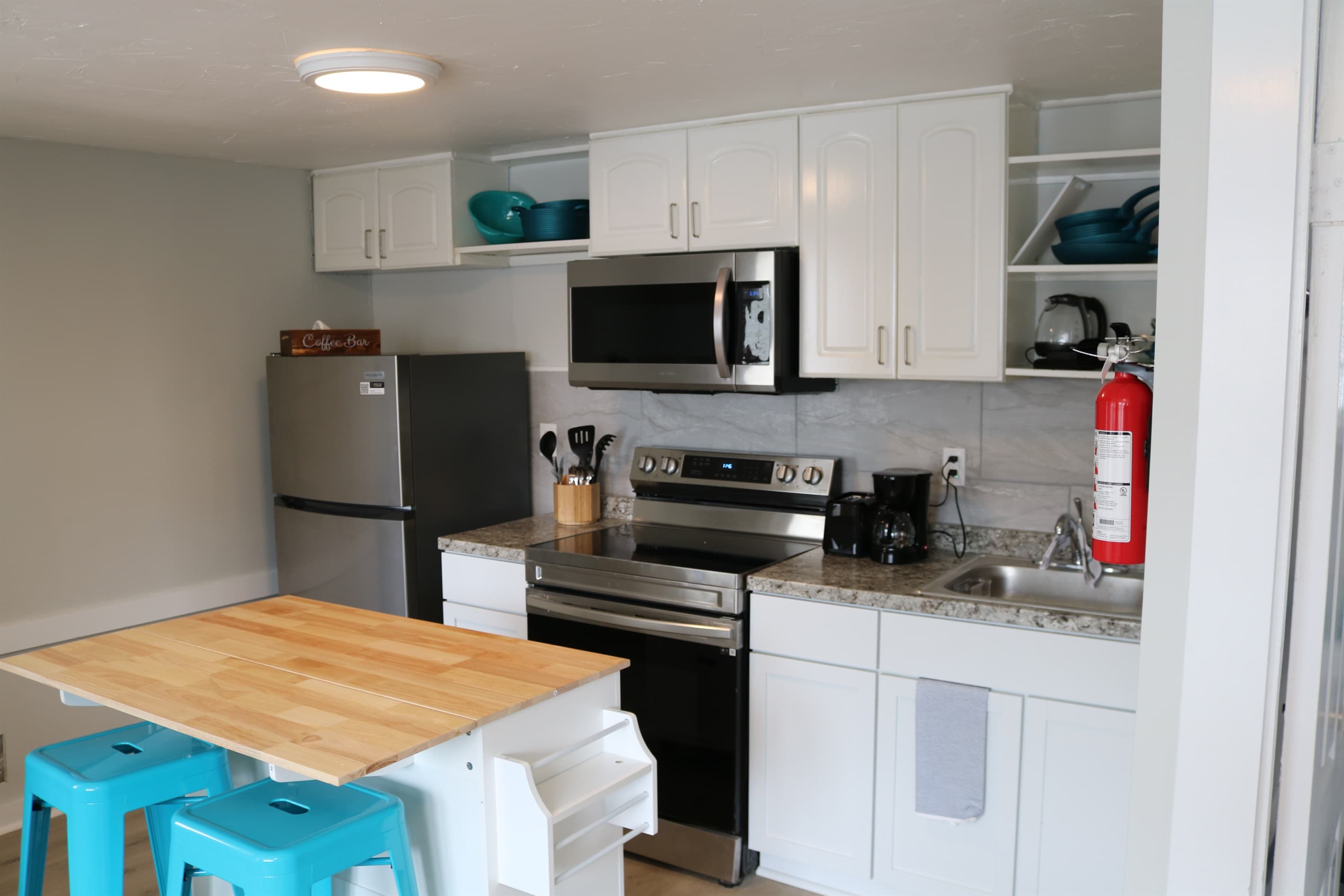 a fully stocked kitchen awaits complete with an island with seating for 2 and all the essentials.