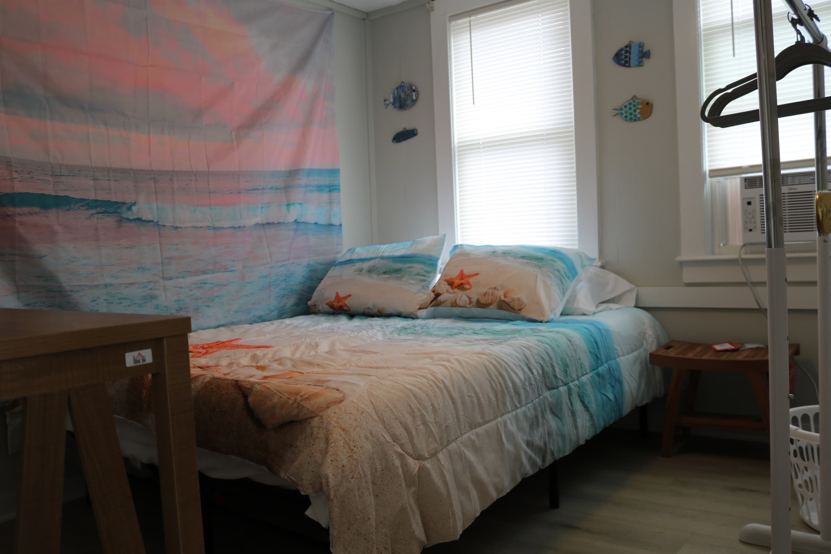 bedroom #1, complete with 32" Amazon Fire TV, a rack for your clothes, and A/C unit