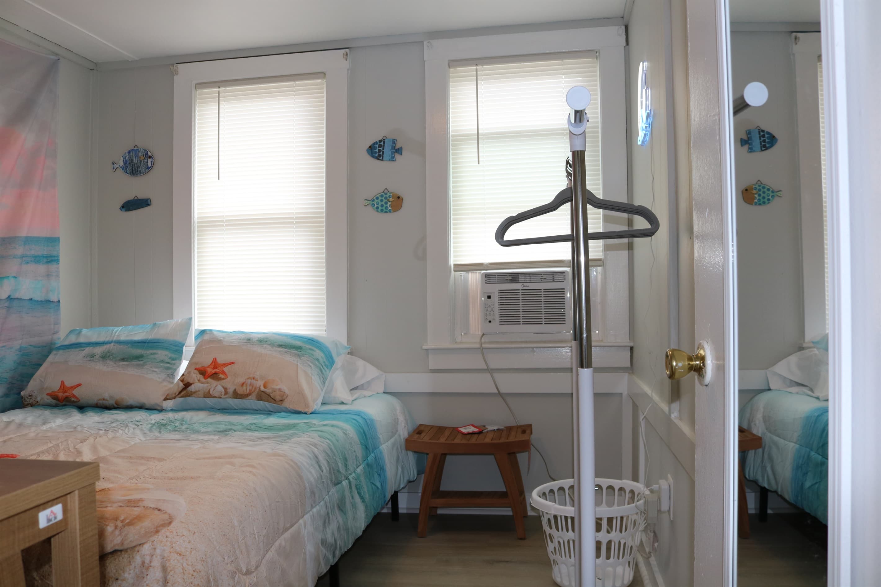 bedroom #1, complete with 32" Amazon Fire TV, a rack for your clothes, and A/C unit