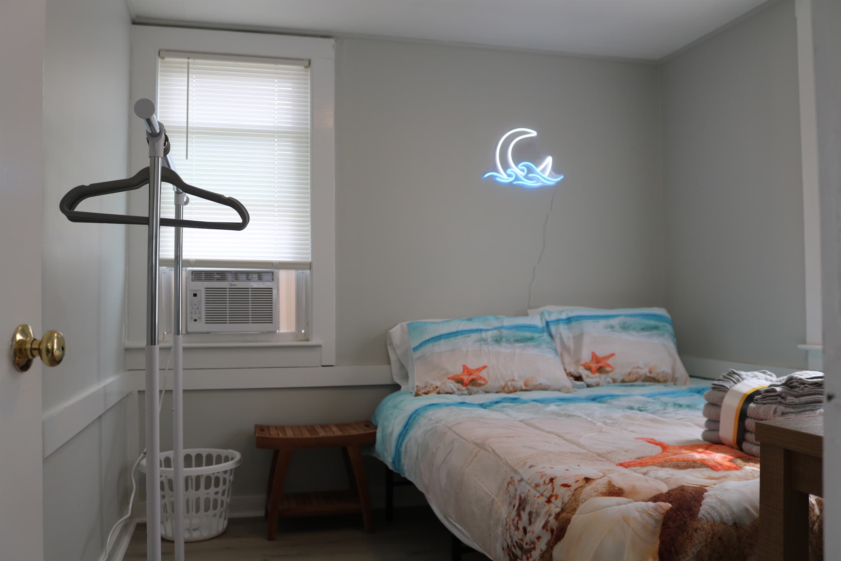 bedroom #2, complete with 32" Amazon Fire TV, a rack for your clothes, and A/C unit