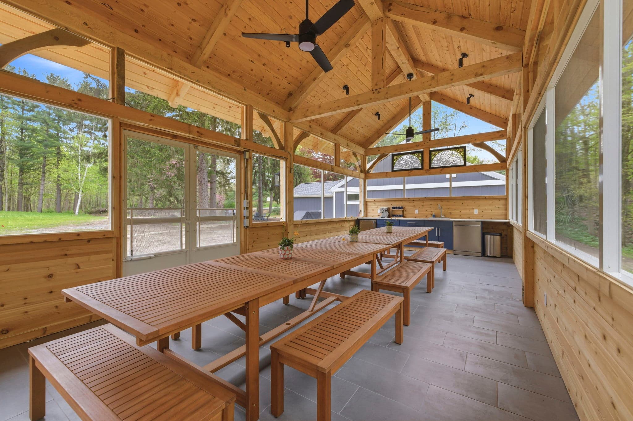 Long dining table in screened pavilion comfortably seats groups up to 17 for shared meals