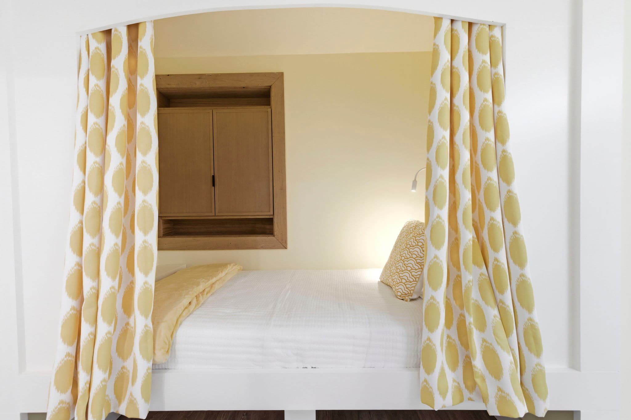 Cozy alcove bed with curtains for additional privacy