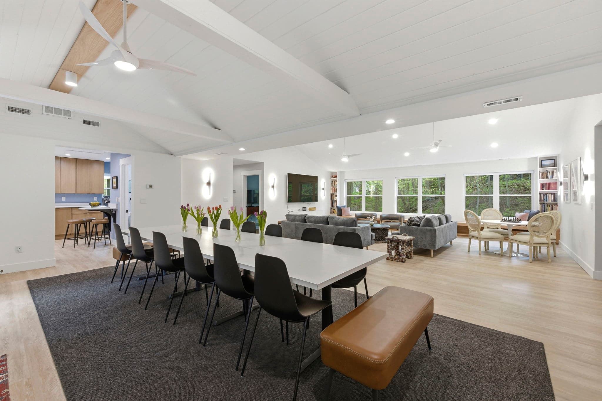 Expansive dining and living area with seating for large groups, designed connection, comfort, and beautiful views