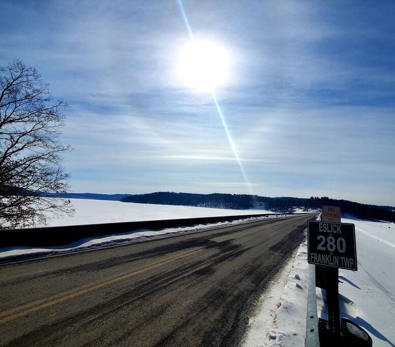 A view of Eslick Rd from SR 250 and frozen Tappan Lake