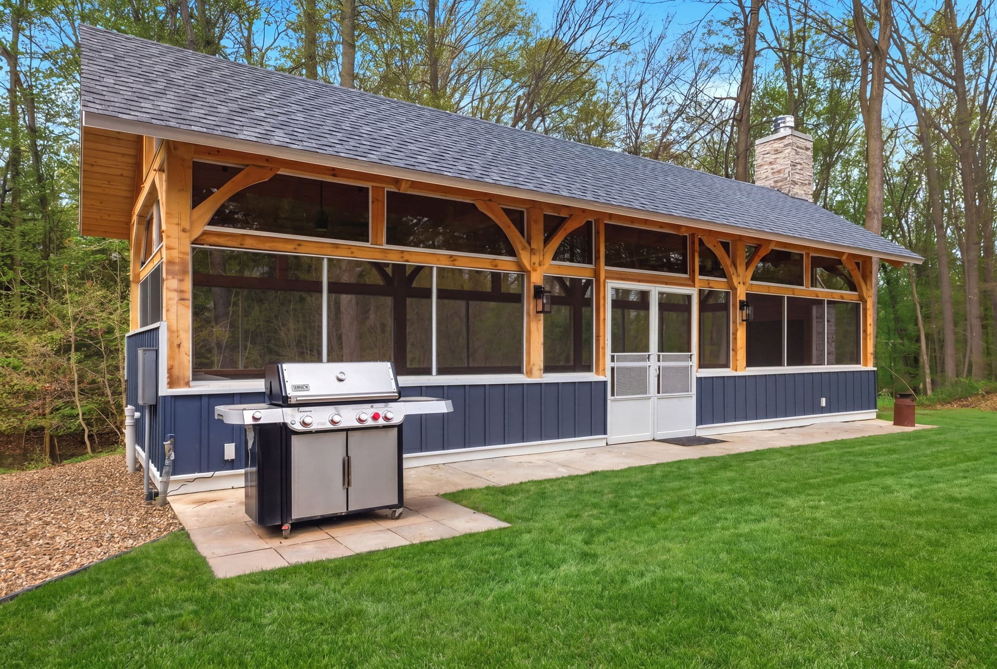 Large, covered outdoor pavilion with kitchenette, BBQ grill, seating and fireplace