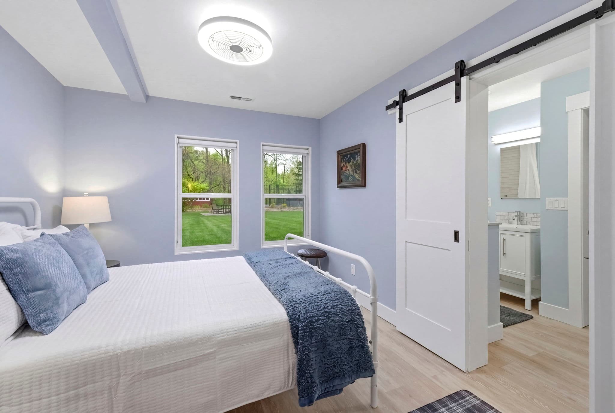 Bedroom Two overlooks the side yard and pool. Jack-and-Jill bathroom on the right.