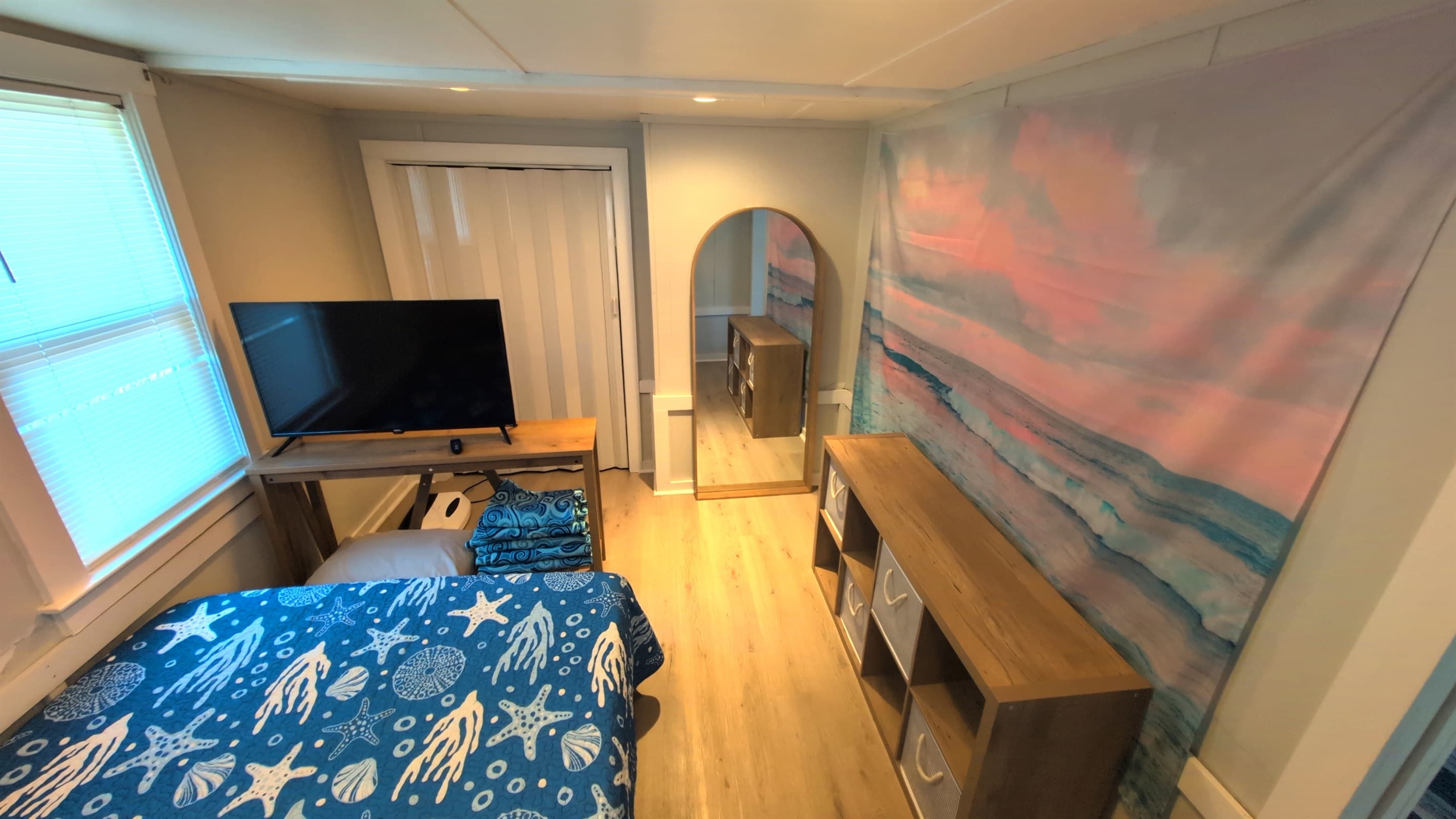 bedroom with queen bed, TV, full mirror & dresser
