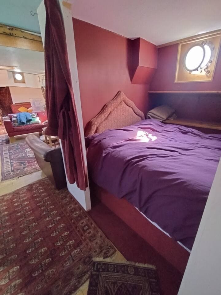 Bedroom 1 is simply one large double bed hidden behind a thick privacy curtain..  A hanging rail and drawer space is available right across the aisle.