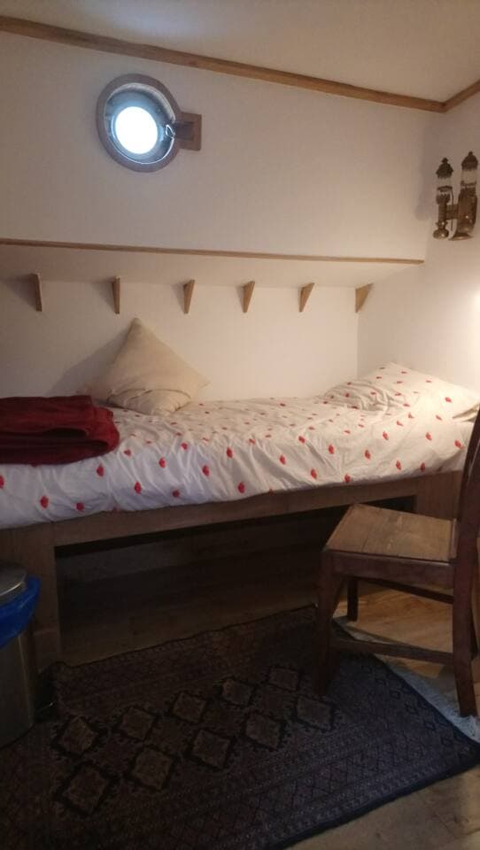 Bedroom 2 has a single bed with storage beneath and to one side. Heating is provided by a blown air system shared with the bathroom.