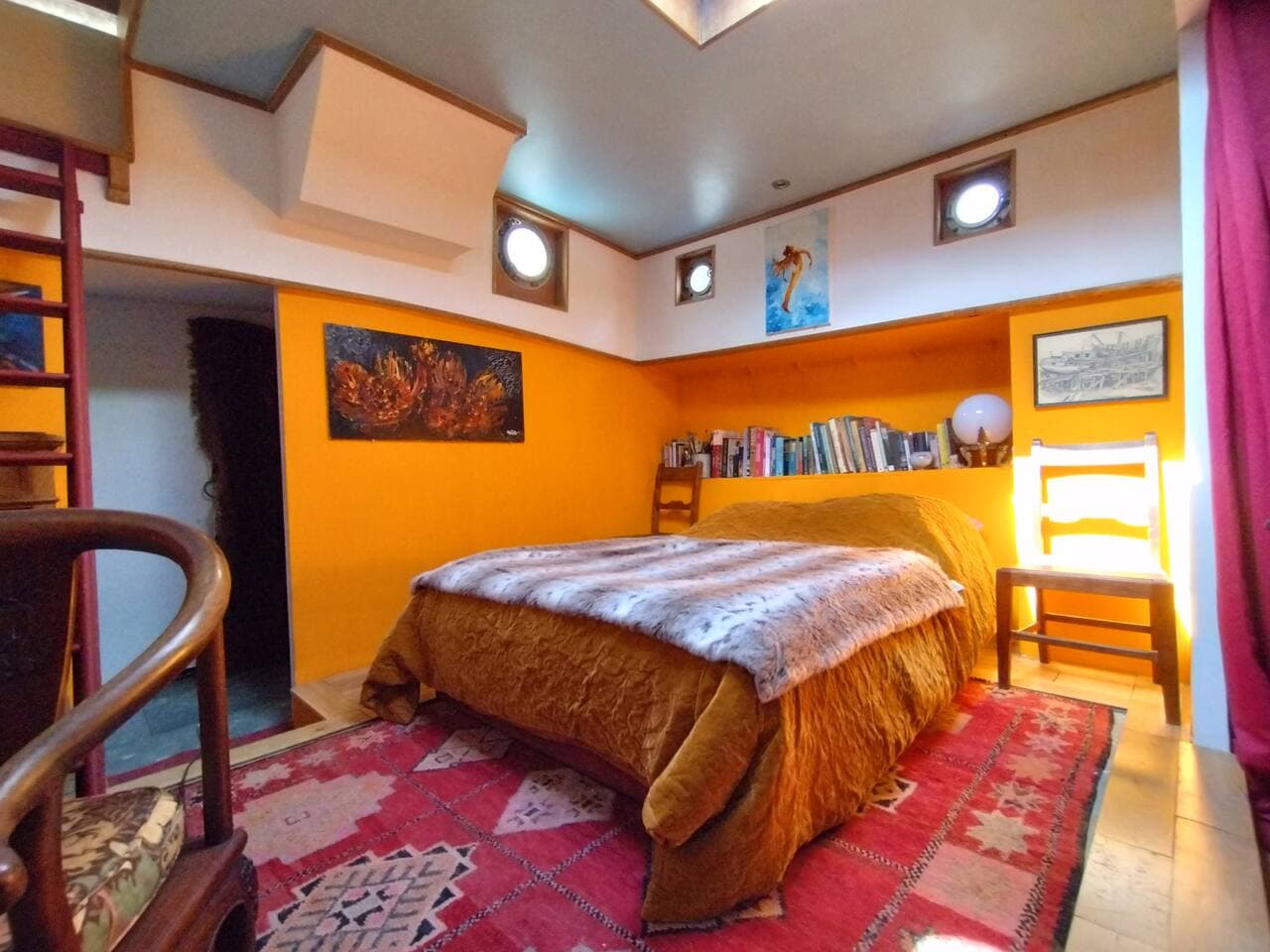 Bedroom 3 has a very comfortable double sofa bed, hardwood floor an with inset Moroccan carpet.  There is storage and a hanging rail in the adjoining tiny room.   There is a library of  books in English.   The space also has an antique work desk.
