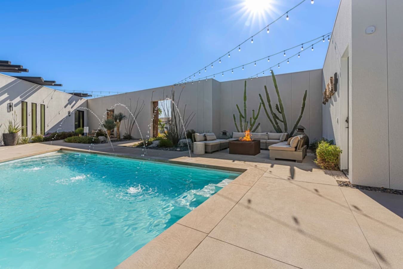 Sparkling pool framed by desert landscaping, privacy walls, and room to cool off on sunny days.