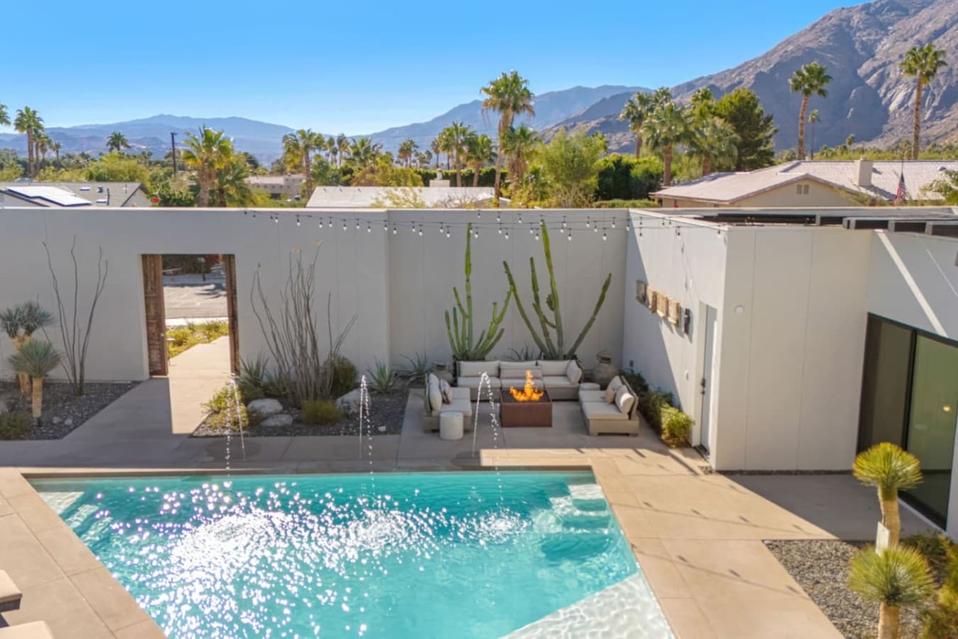 Private pool courtyard w/ palm trees, shaded seating, and a refreshing dip just steps from the house.
