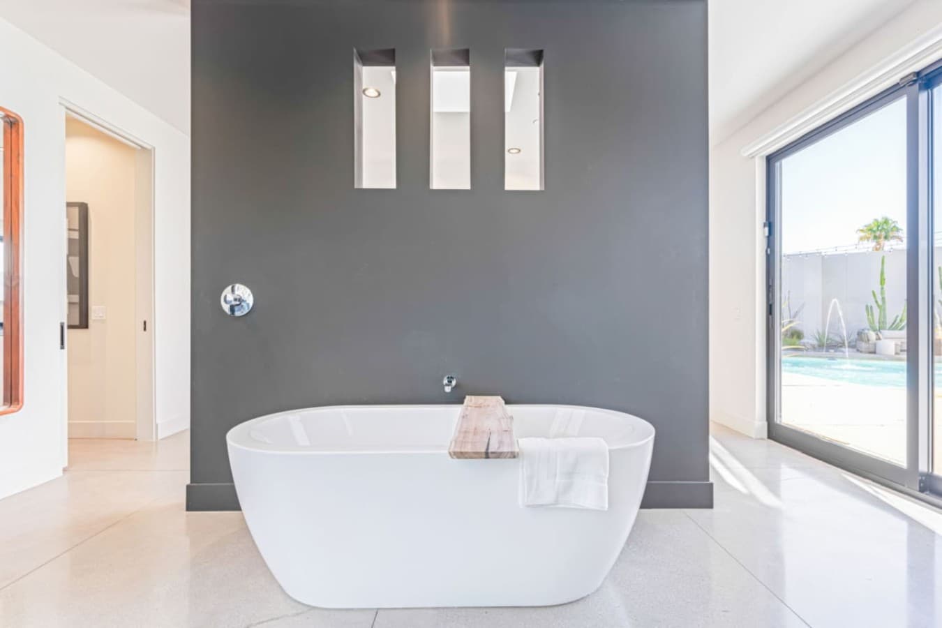 Minimalist bathroom retreat w/ deep soaking tub, clean lines, and soft light for a calming escape.