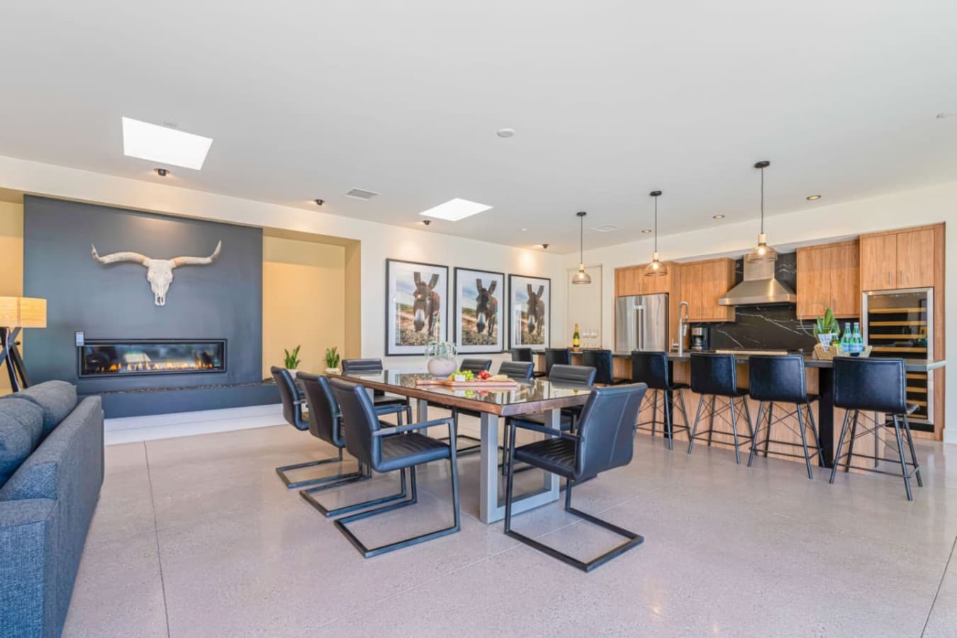 Large dining area w/ statement table, modern lighting, and room for everyone to sit together.