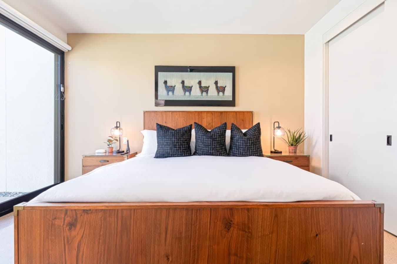 Minimalist bedroom setup w/ crisp linens, soft light, and a relaxed desert vibe.