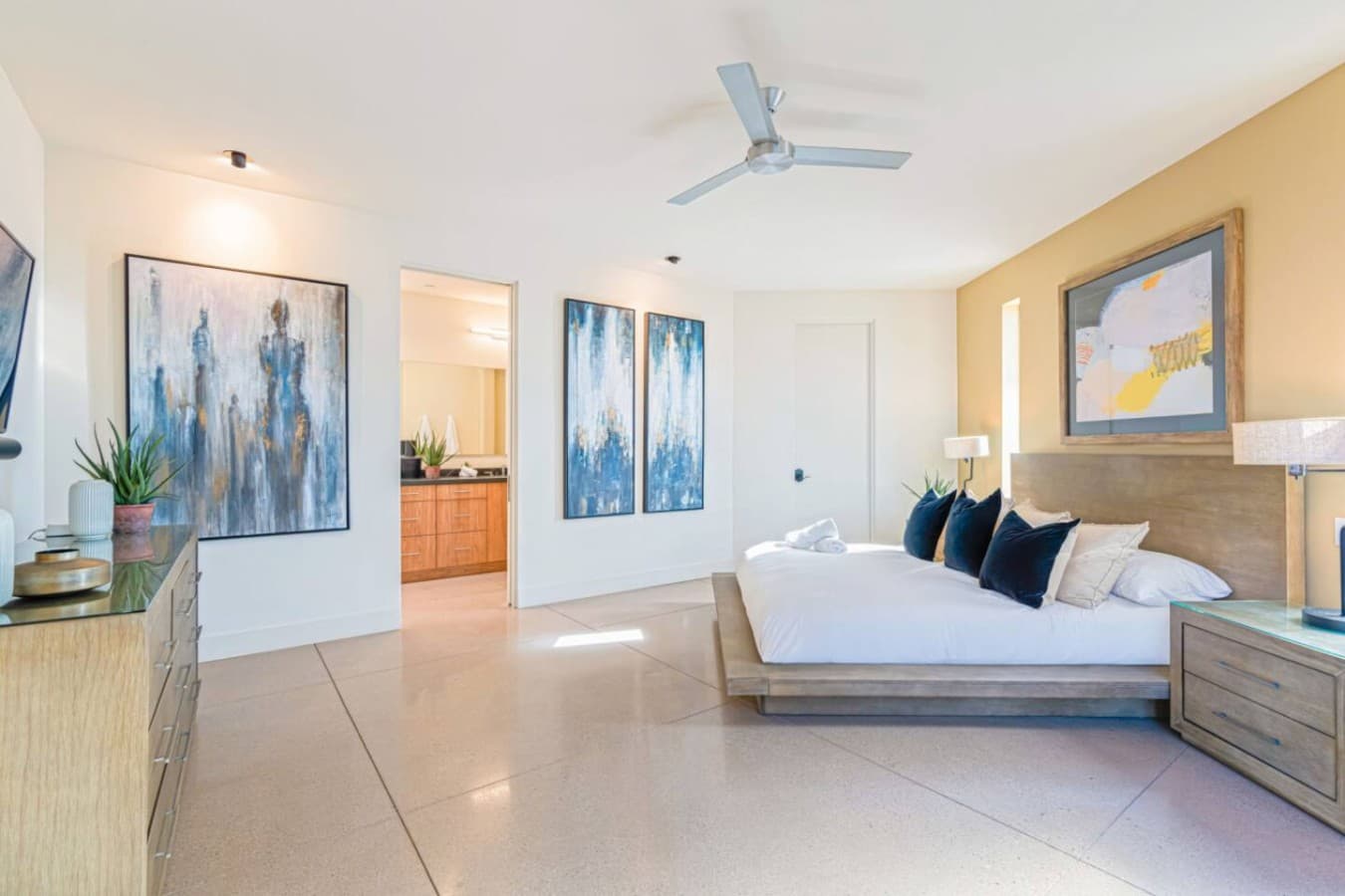 Spacious primary suite w/ king bed, sitting area, and soft desert light filling the room.