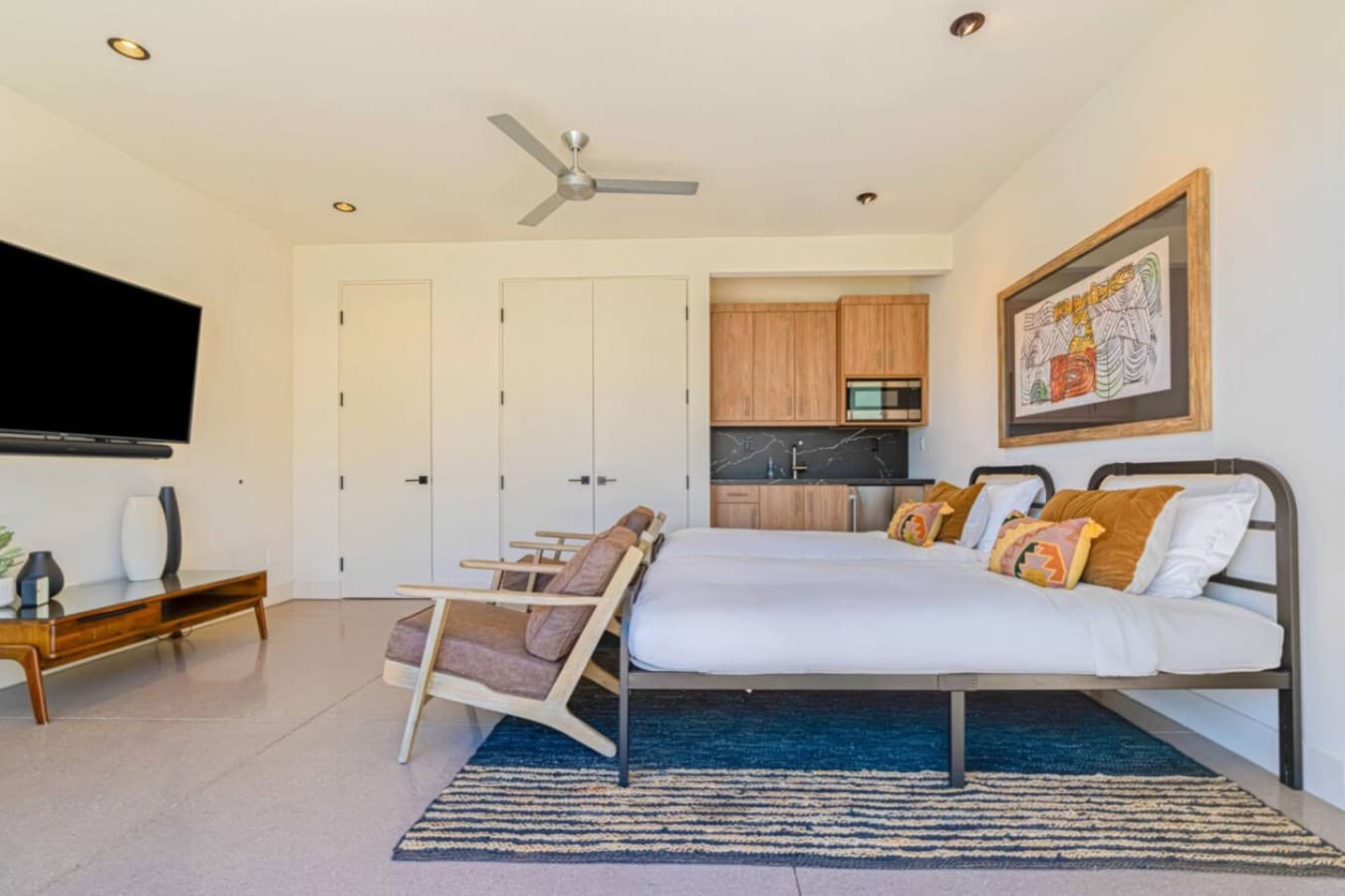 Relaxed bedroom layout w/ comfy seating, ceiling fan, and an easy flow into the bath.