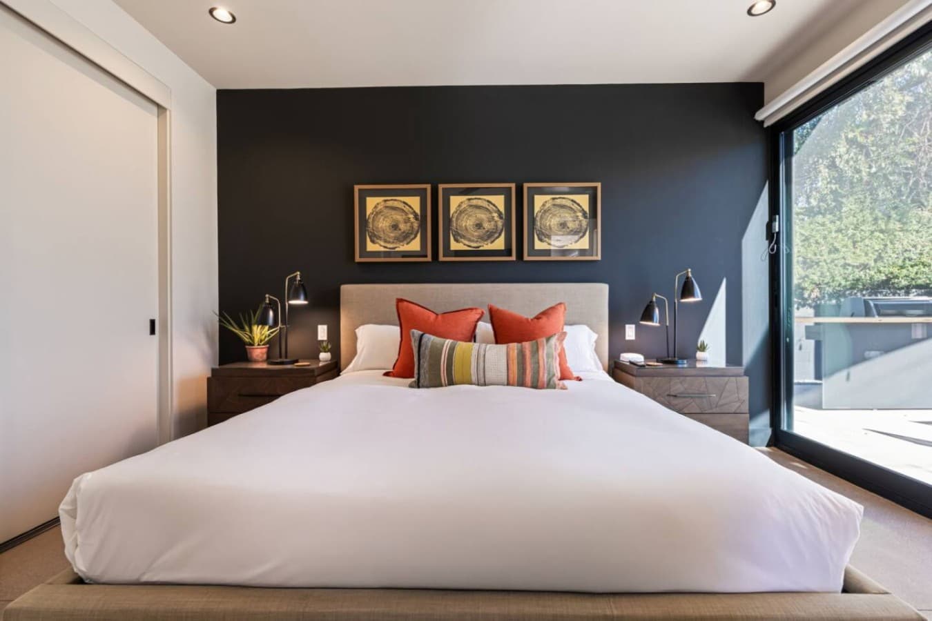 Inviting king bedroom w/ bold artwork, soft lighting, and a peaceful feel for winding down.