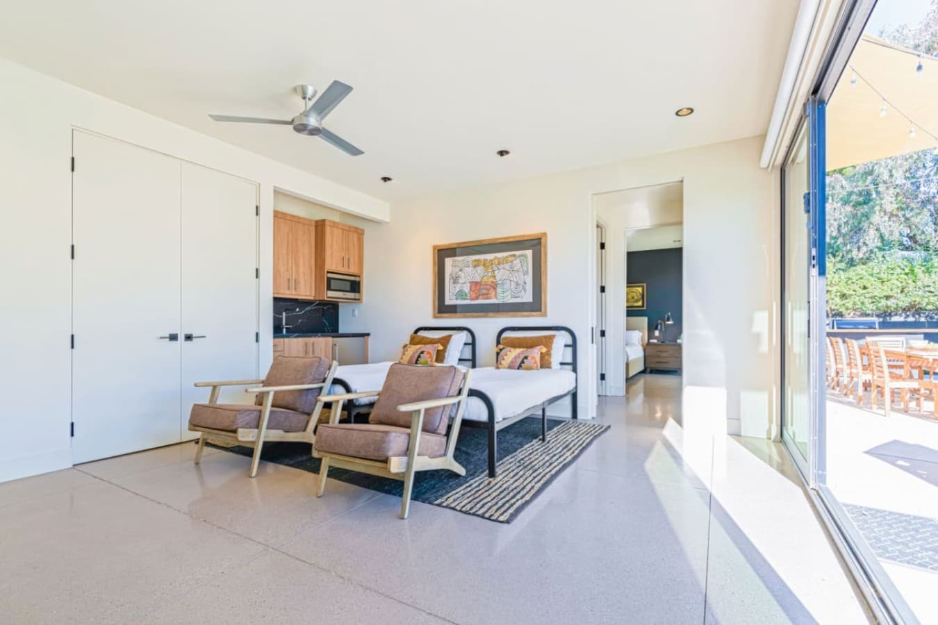Comfortable sitting nook w/ desk, lounge chairs, and views into the bright living space.