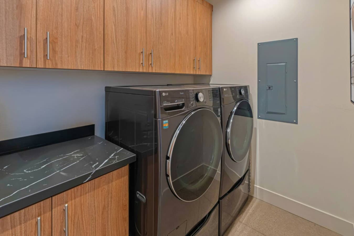 In-unit laundry nook w/ stacked washer & dryer tucked neatly into a clean, modern cabinet space.