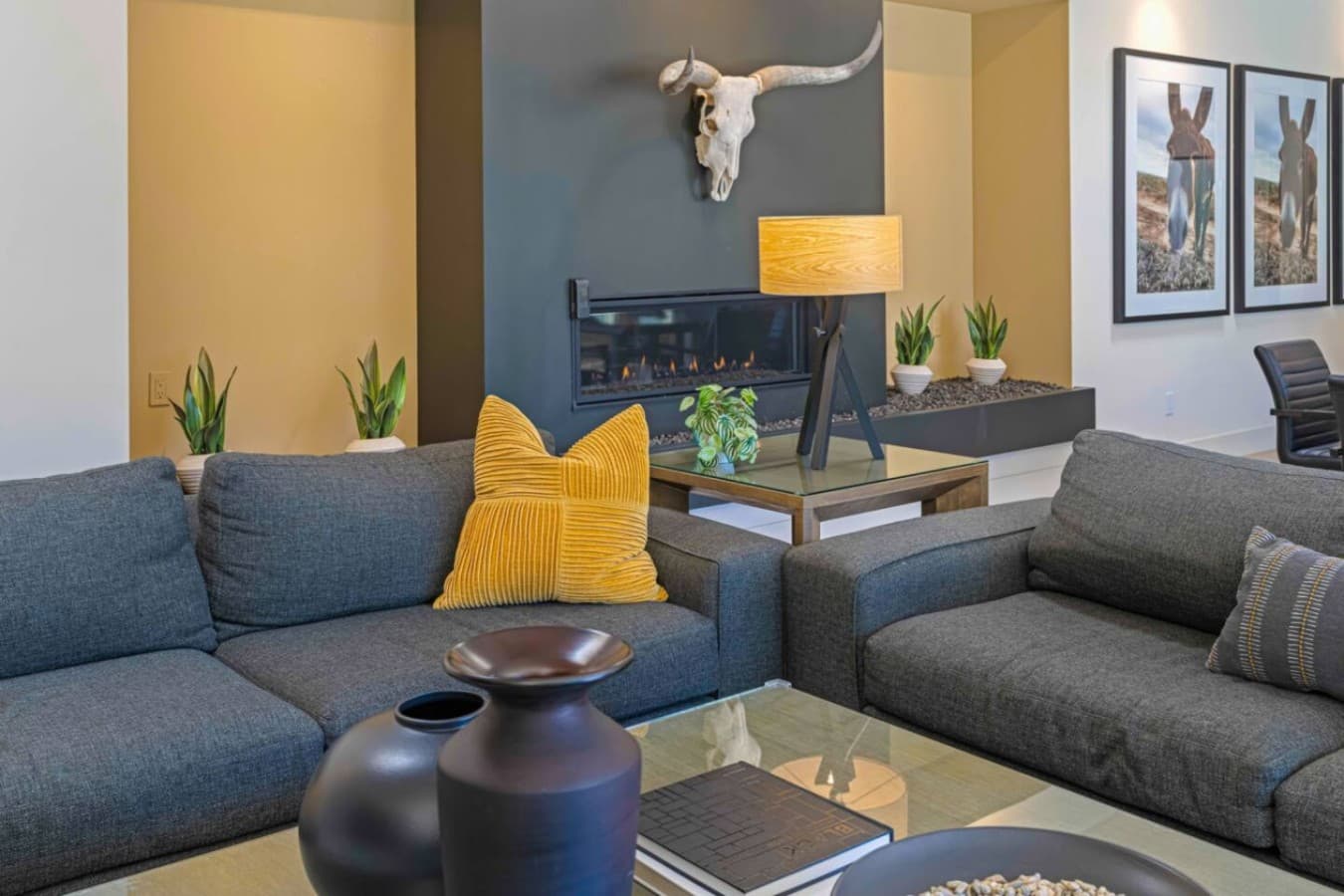 Cozy living room w/ textured sofa, layered pillows, and an inviting spot to relax after a day out.