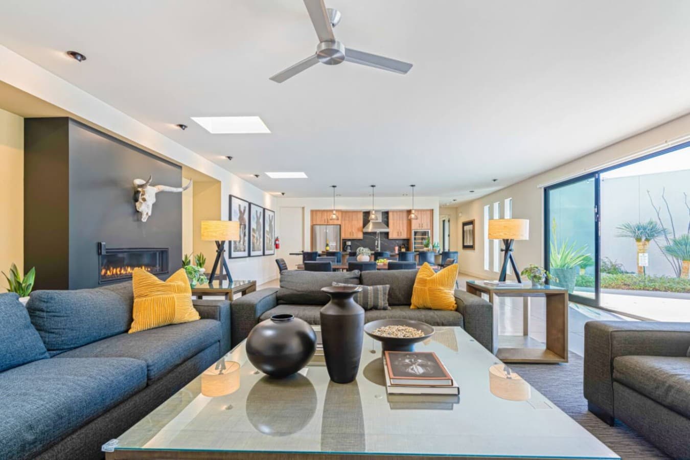 Stylish open-concept living area w/ modern furnishings, statement lighting, and plenty of space to gather.