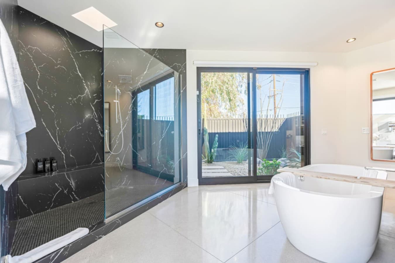 Spa-style bathroom w/ soaking tub, glass shower, and natural light for slow mornings and easy unwinding.
