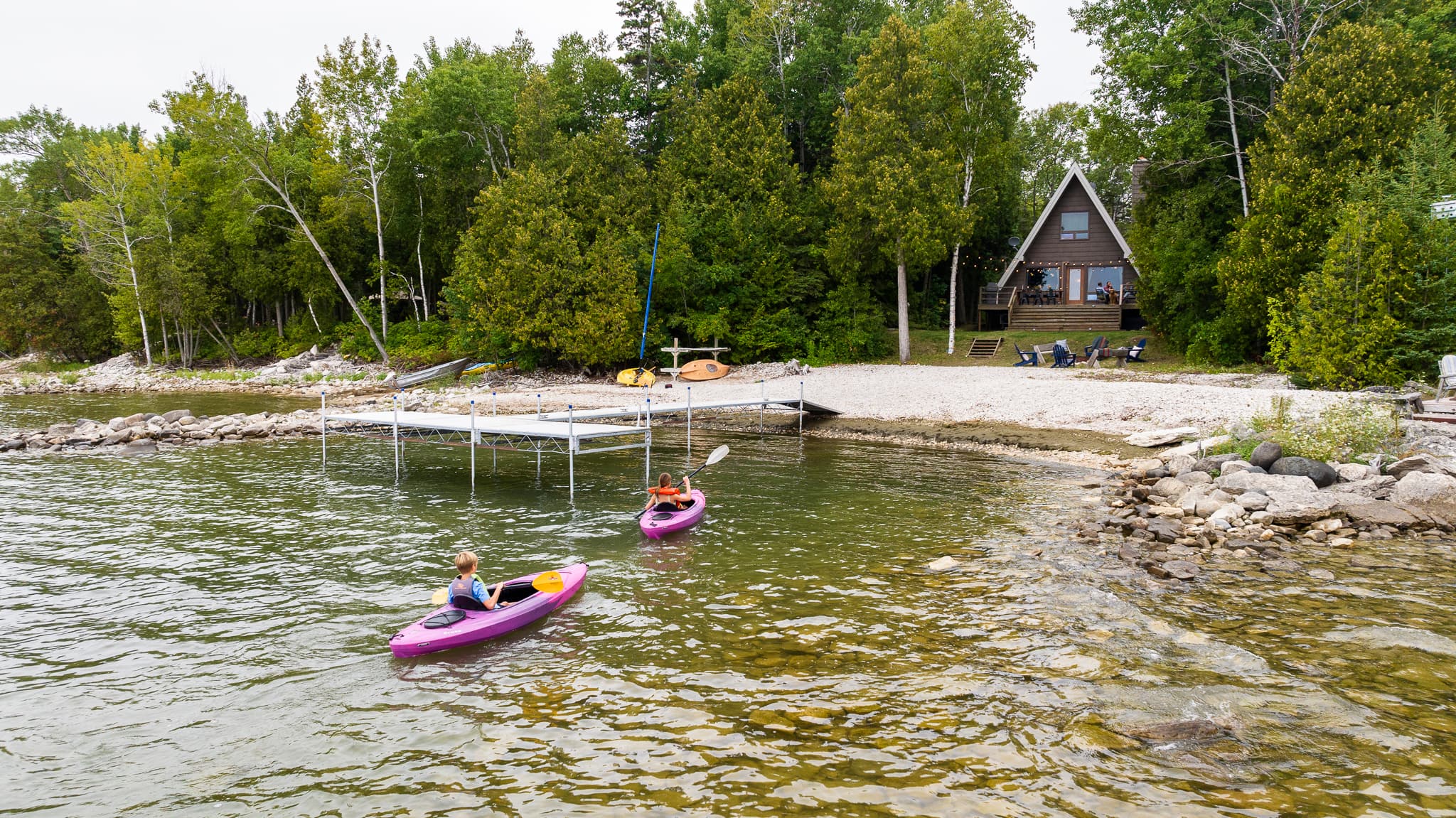 Kayaks and canoes waiting for you right on the shore to explore Rowley's Bay.