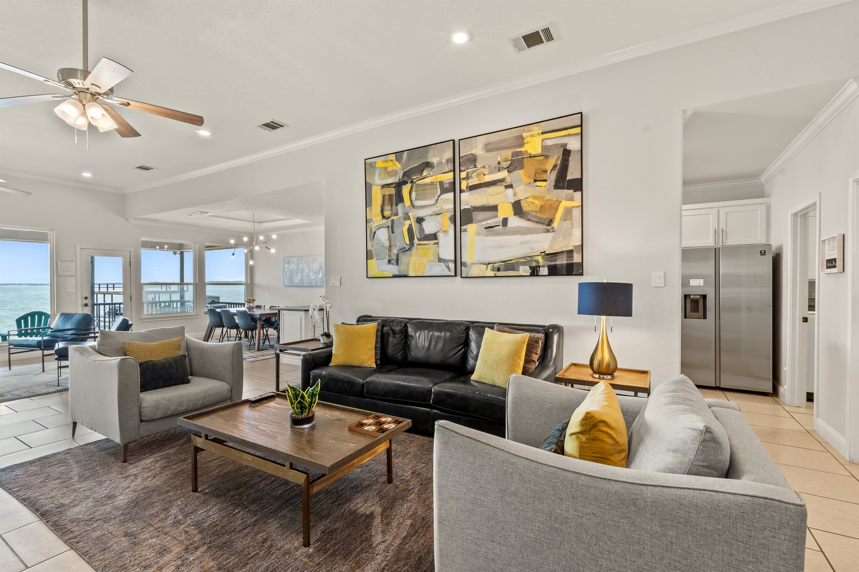 Comfortable living spaces featuring plush seating and floor-to-ceiling windows with uninterrupted open water views.