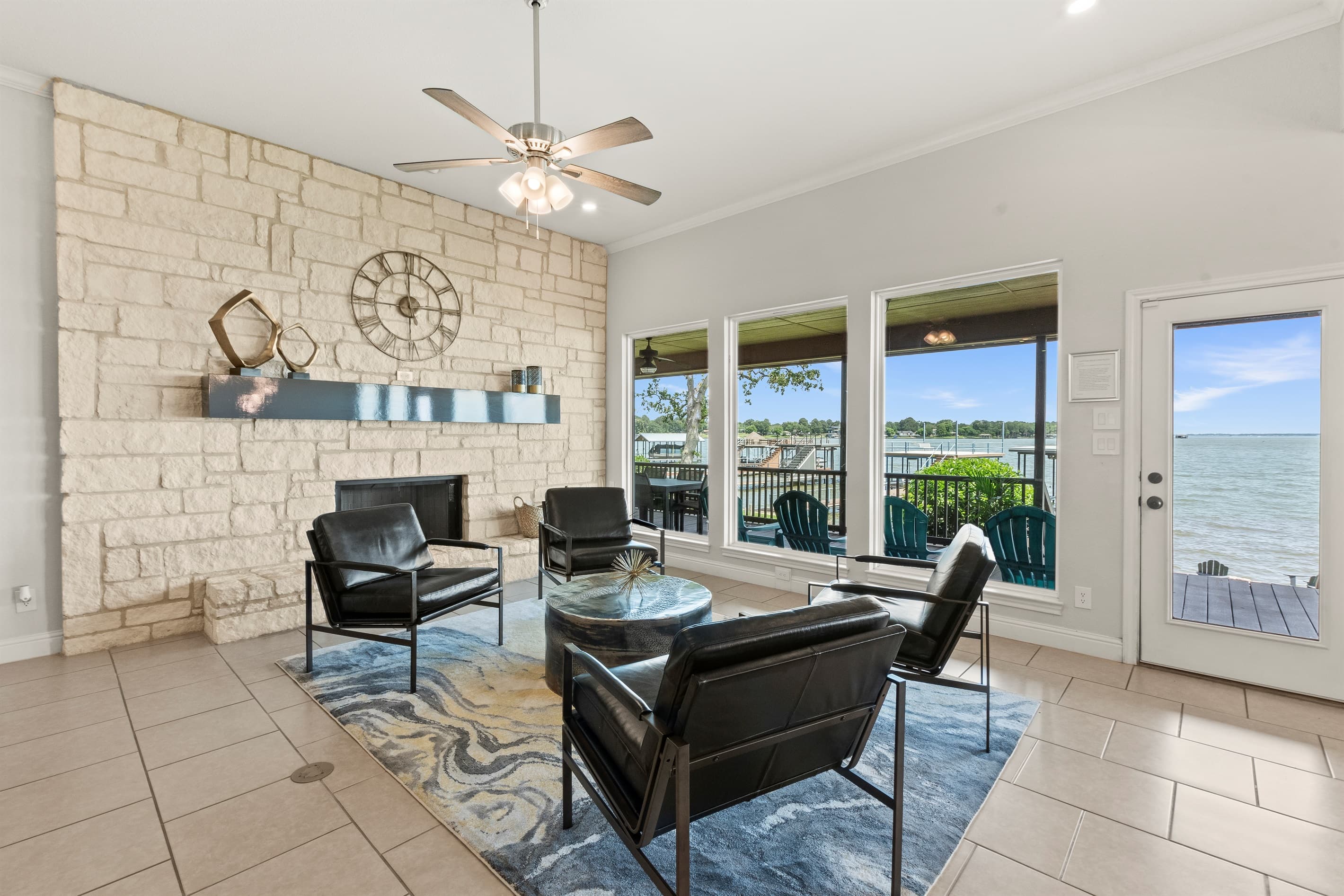 Family room designed for cocktails and conversation, featuring expansive windows with stunning lake views.