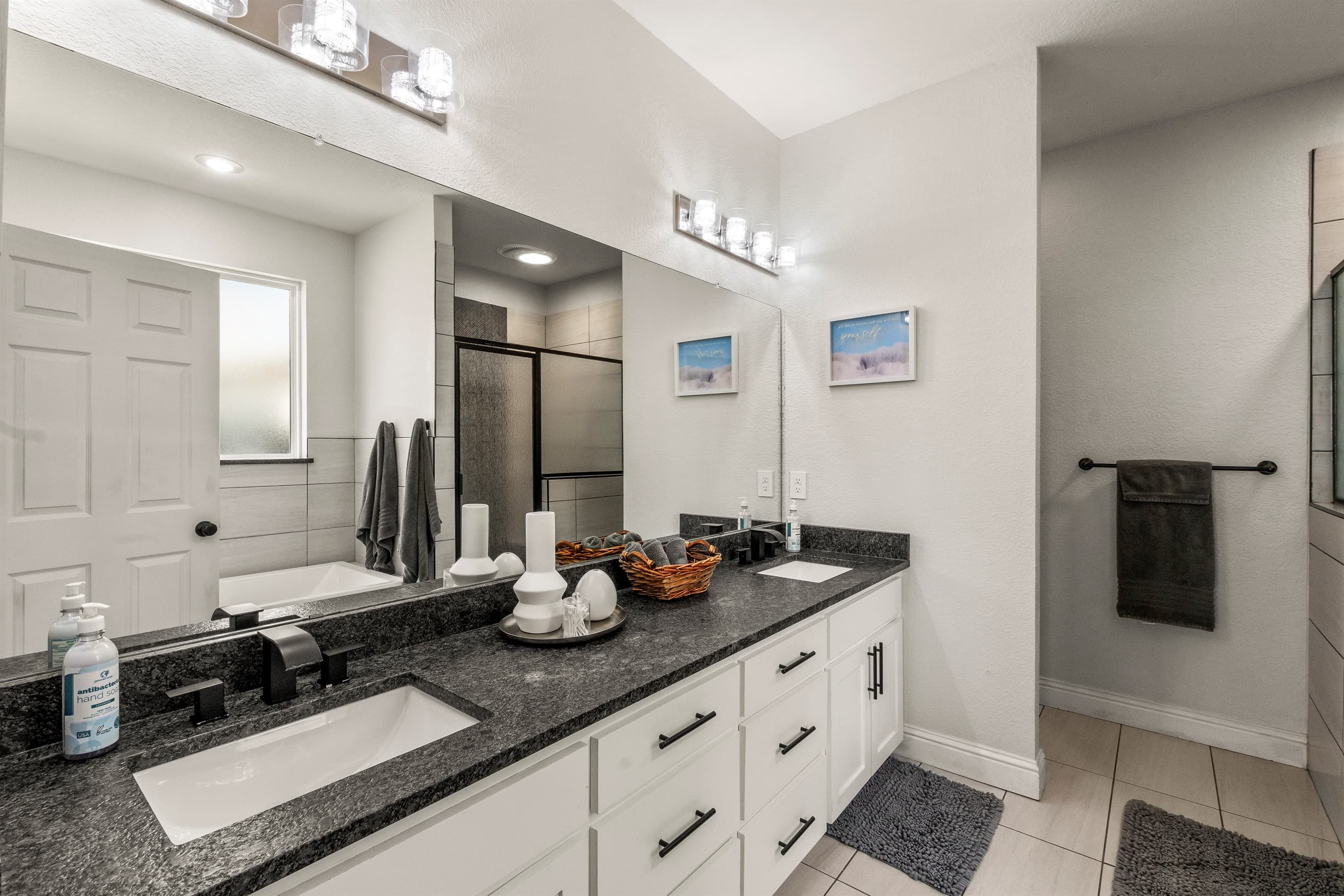 Main bathroom features a luxurious Jacuzzi tub alongside a separate, spacious shower for ultimate relaxation.