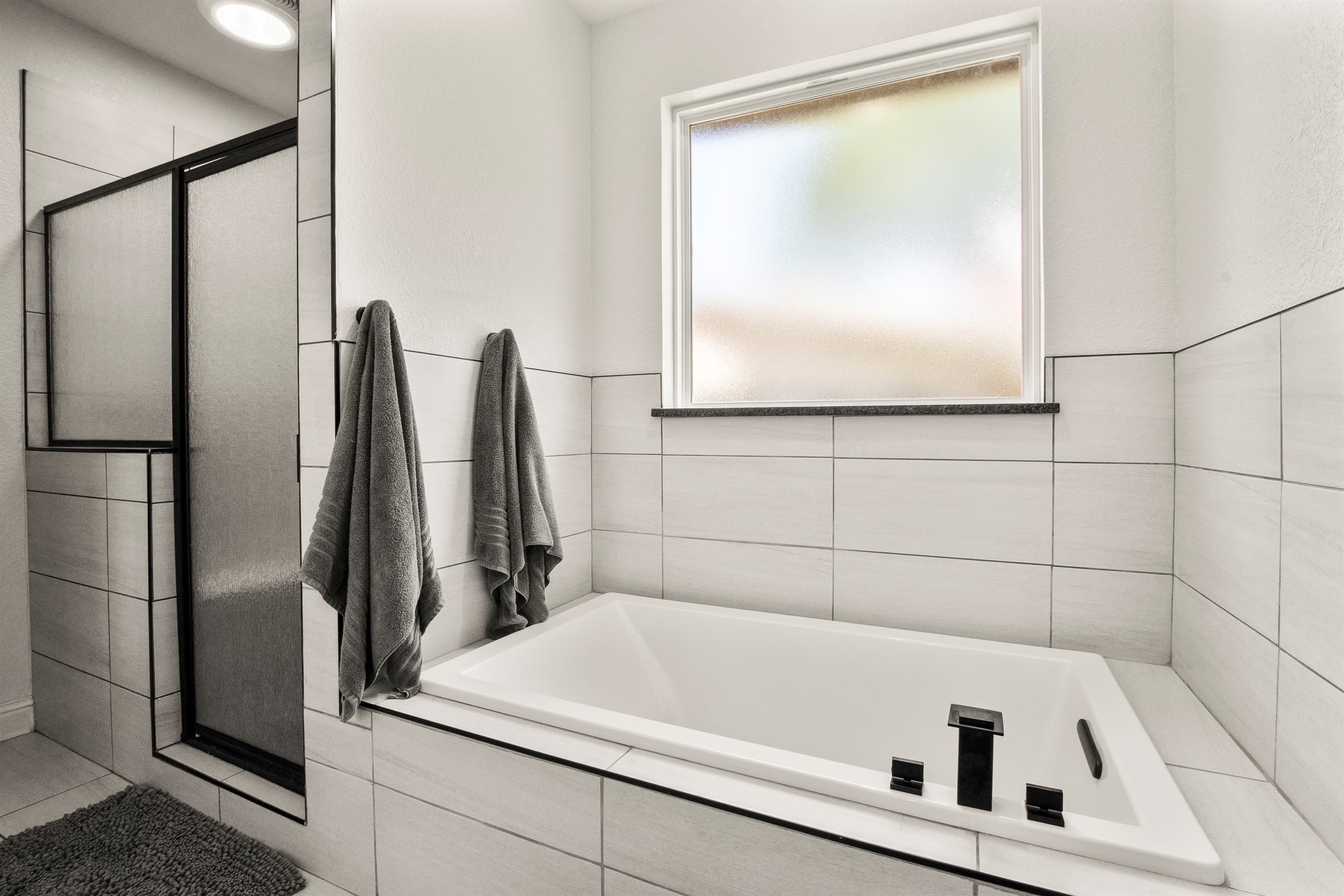Main bathroom with a separate shower and a relaxing Jacuzzi tub for spa-like comfort.