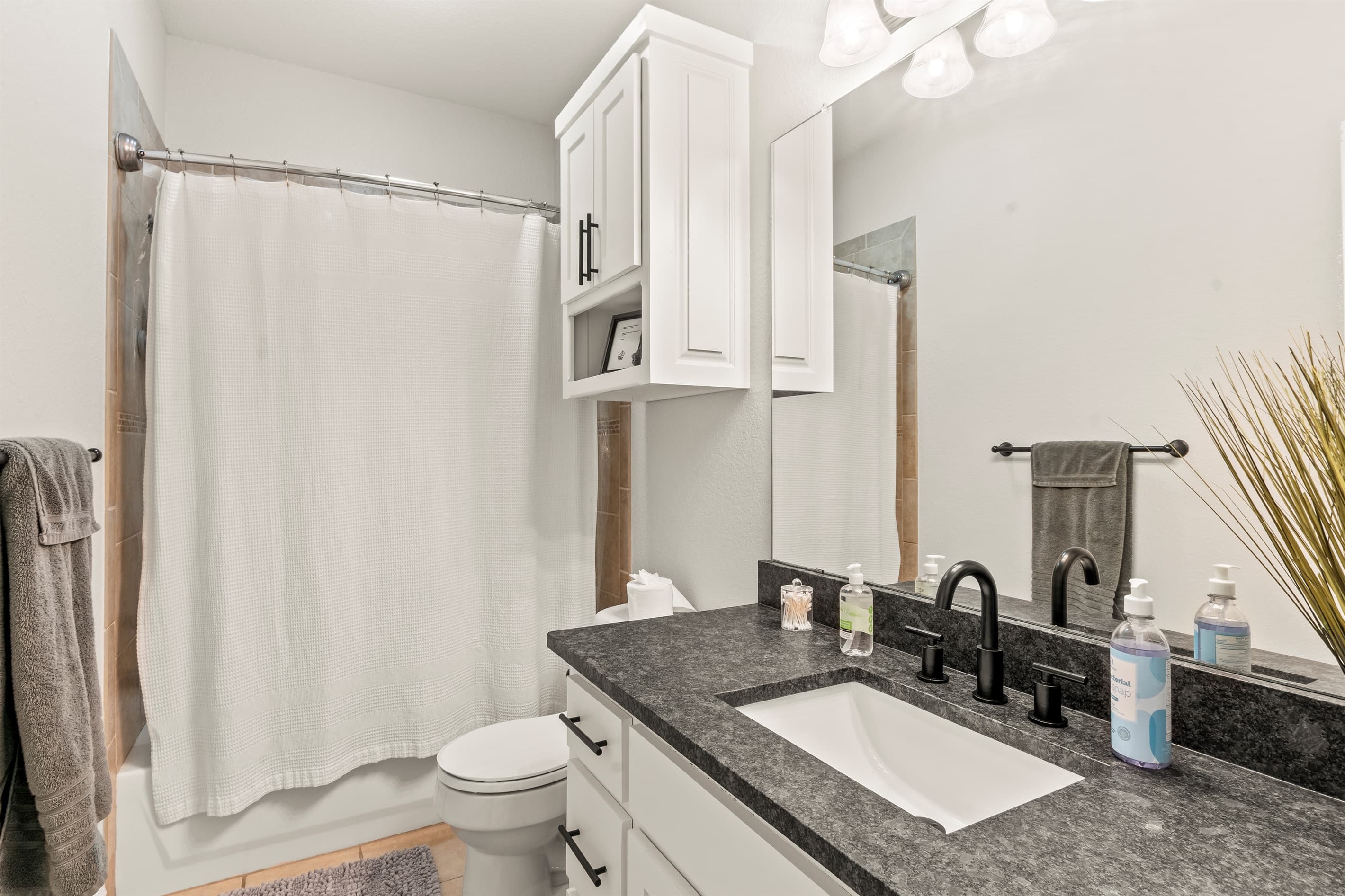 A stylish en-suite bathroom with modern finishes, designed for both comfort and privacy.