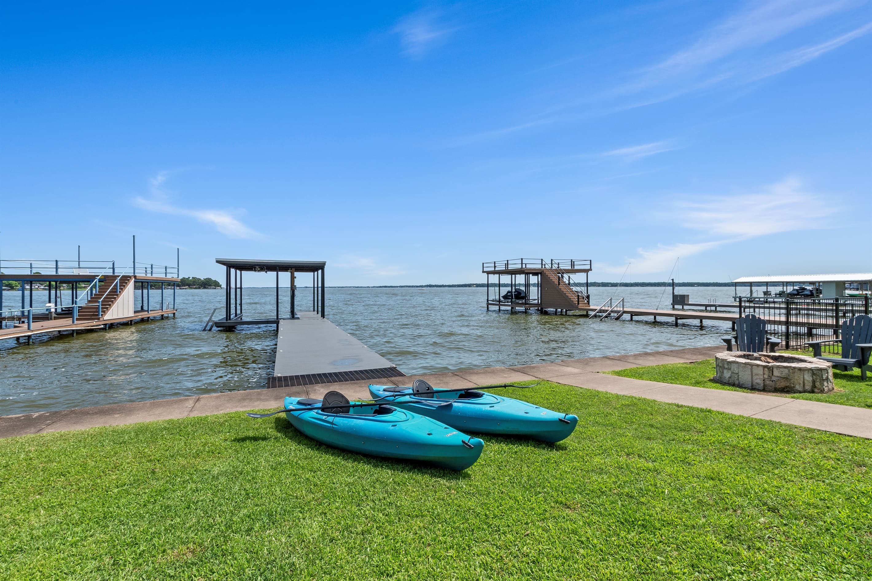 Paddle into adventure—two kayaks ready for you at the dock, with breathtaking open water views of Cedar Creek Lake.